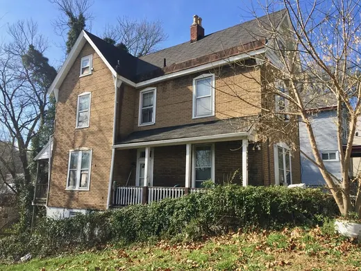 Two-story brick home with a covered porch