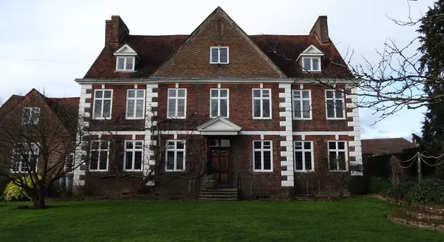 Brick country house with a steep tiled roof