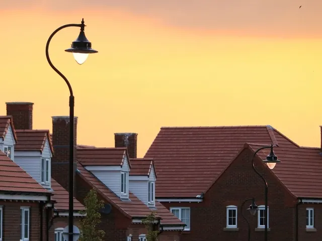 Row of brick houses with tiled roofs at sunset