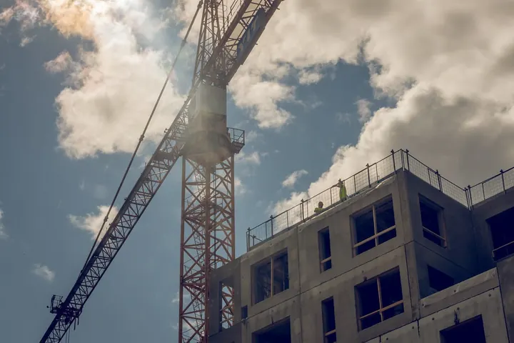 Tower crane beside a building under construction