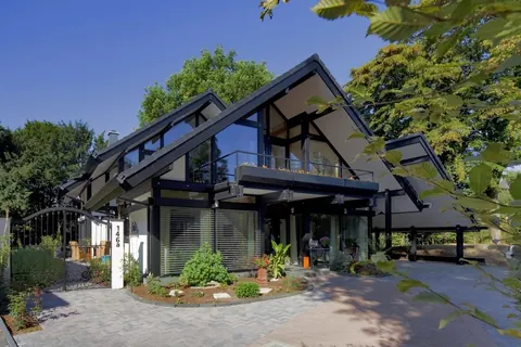 Contemporary villa with large windows among trees