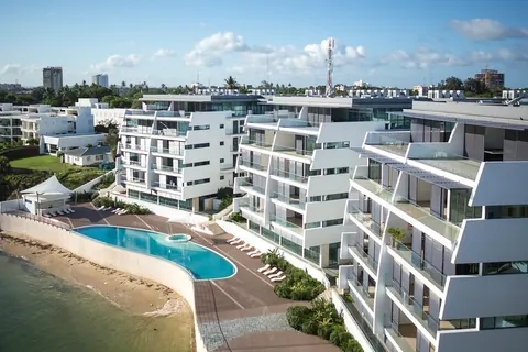 White low-rise residences beside the sea